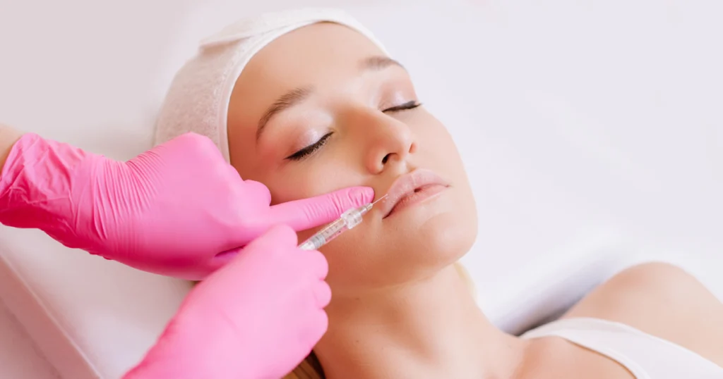 A woman receiving Belotero lip filler injection by a professional in Rochester Hills, MI